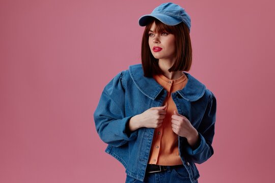 Pretty young female denim cap red lips glamor fashion pink background unaltered