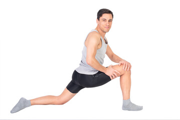 Positive sportsman doing stretching exercise in studio