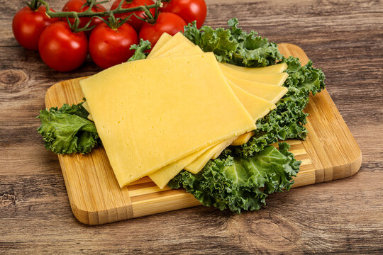Sliced Gauda cheese over board