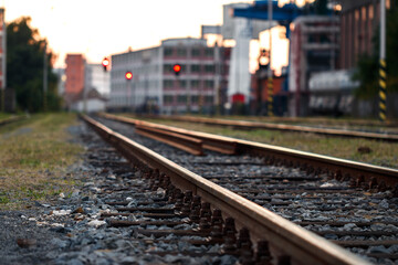 Fototapeta na wymiar Railroad track at industrial area. Selective focus. Rail transportation. Railway in city