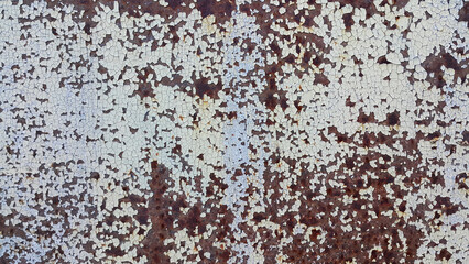 Texture of weathered metal wall with cracked paint and rust
