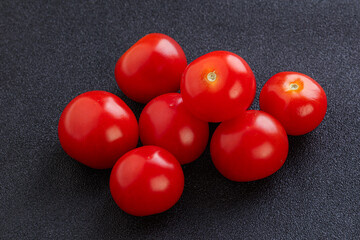 Ripe juicy cherry tomatoes heap