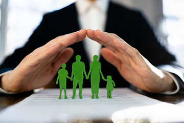 Cropped Image Of Businessman Covering Paper Family