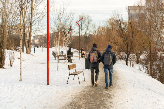 Two Students Walk Home From School After School On A Winter Day