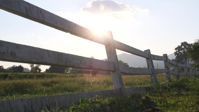 White fence in the countryside at sunset.