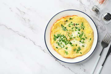 Omelette or frittatas with green onions or young greenery and mozzarella on white marble table background. Healthy food concept. Breakfast. Copy space. Top view. Mock up.