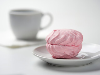 Dessert. Pink marshmallow on a white background.