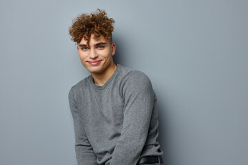 Fototapeta na wymiar handsome young man in a gray sweatshirt fashion studio Lifestyle unaltered