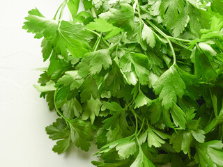 Green juicy parsley on a white background. fresh seasoning