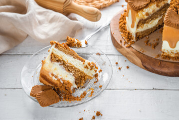 A slice of homemade sponge cake, cookie with cream, cookies and caramel, ready to eat, a delicious dessert.