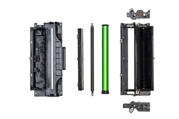 Isolated disassembled black and white laser printer cartridge parts on a white background