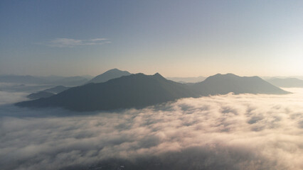 Sea of Fog covers the area on the top of hill Doi Phu Thok, Chiang Khan, Loei, Thailand with background of sunrise on winter. 