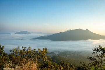 Sea of Fog covers the area on the top of hill Doi Phu Thok, Chiang Khan, Loei, Thailand with background of sunrise on winter. 