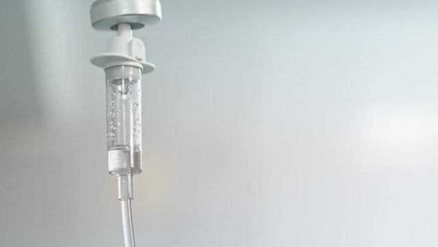 Close-up of the Infusion Process. Drop of Saline is Dripped for Intravenous Infusion IV During Chemotherapy. Slow Motion.