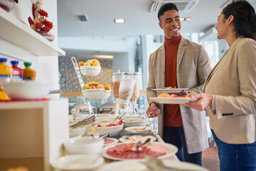 business colleagues having lunch at office cafeteria