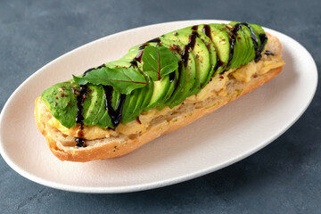 Baguette sandwich with scrambled eggs and avocado for breakfast. Proper nutrition concept. Vegan sandwich.