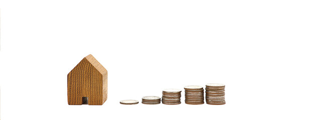 Wooden house with coins on white background.