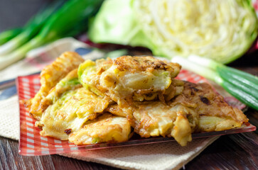 Cabbage fried in batter on a plate.