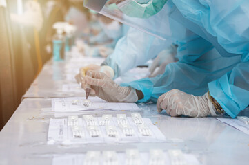 blur background of group doctors wearing anti-virus clothing testing coronavirus covid-19 on people...