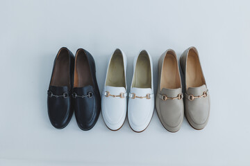 Lots of women's shoes on the floor, different leather shoes. New women's shoes scattered on the floor