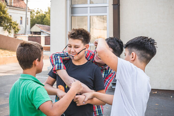 Group of schoolboys bullying a boy. Children abusive behavior