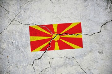An old image of the flag of North Macedonia on a wall with a crack.