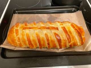 A close up view of a freshly baked beef wellington straight out the oven