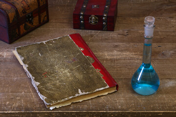 a closed old notebook for writing on an old wooden table, old strange objects