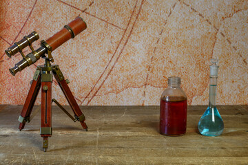 on the drawing table are the researcher's tools: a telescope, flasks with a reagent (magic potion)...