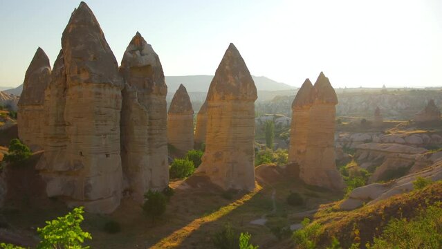 Amazing unusual landscape of turkish scenic Cappadocia. Sunset or sunrise time over mountains of Turkiye (Turkey) country. Amazing scenery of ancient canyons, plains, valleys and mountains