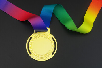 Gold medal with ribbon on black background	