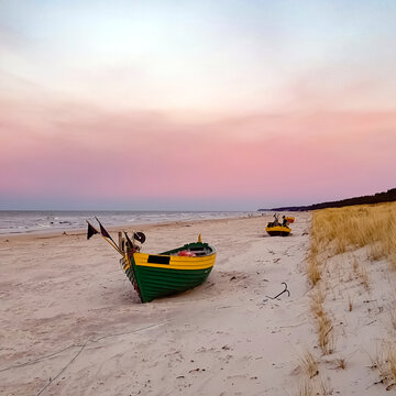 Colorful fishing boat on the beach at sunset, Dębki, Poland