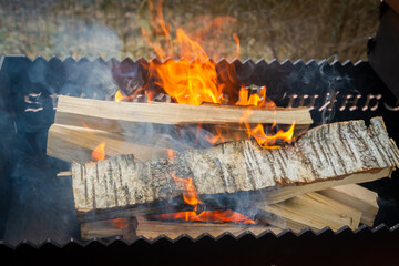 Dry wood in the grill for kindling and making coals - 488168103
