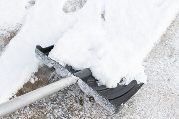 Snow cleaning with a large shovel in winter - 488168978