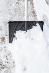 Snow cleaning with a large shovel in winter - 488168996