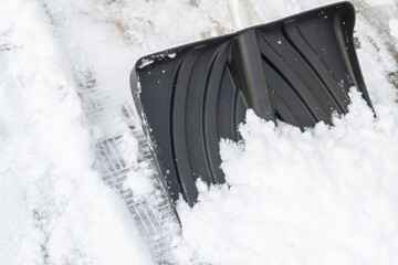 Snow cleaning with a large shovel in winter - 488169100