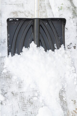 Snow cleaning with a large shovel in winter - 488169101