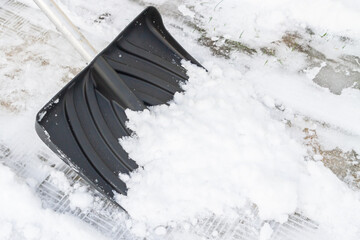 Snow cleaning with a large shovel in winter - 488169163