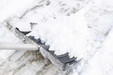 Snow cleaning with a large shovel in winter - 488169164