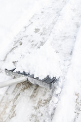 Snow cleaning with a large shovel in winter - 488169181