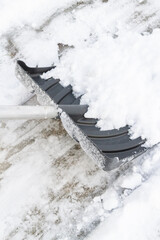 Snow cleaning with a large shovel in winter - 488169182