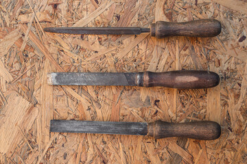 woodworking tools. chisels on a wooden background. chisels with wooden handles. vintage instrument. home workshop. carpentry tools.
