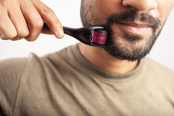 man using microneedling as a beard growth treatment
