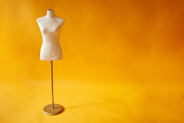white mannequin on yellow background