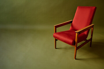 red chair on olive green background
