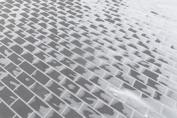 Paving slabs in the snow in winter.