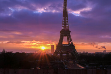 Urban landscape. Silhouette of Eiffel tower with dramatic sky in the background. Sunrise or sunset over the city of Paris.