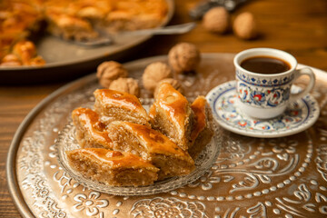 Baklava with nuts on a wooden background. Selective focus.
