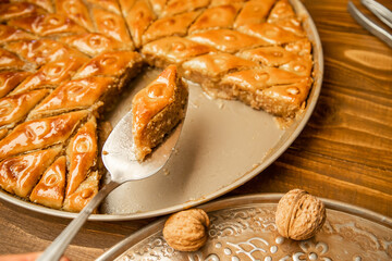 Baklava with nuts on a wooden background. Selective focus.