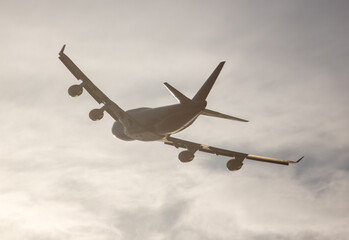 Silhouette of an airplane at sunset.